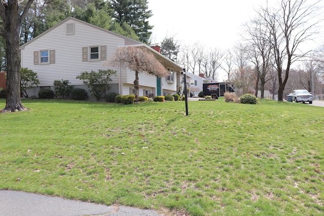 1 Sunrise Cir, Enfield, CT 06082 - view of property exterior with a yard and a chimney