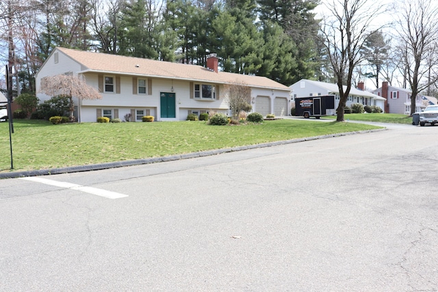 1 Sunrise Cir, Enfield, CT 06082 - split foyer home with driveway, a front lawn, a garage, and a chimney