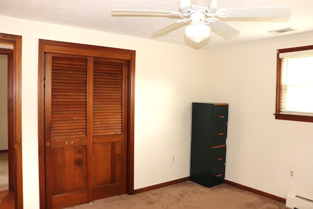 1 Sunrise Cir, Enfield, CT 06082 - unfurnished bedroom with baseboard heating, baseboards, light carpet, visible vents, and ceiling fan
