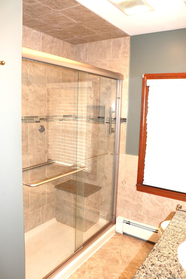 1 Sunrise Cir, Enfield, CT 06082 - full bath with a shower stall, visible vents, a baseboard radiator, and tile walls