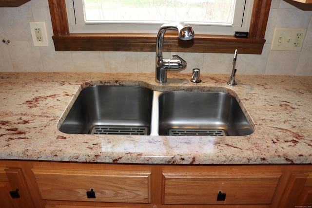 1 Sunrise Cir, Enfield, CT 06082 - room details featuring a sink, backsplash, and light stone counters