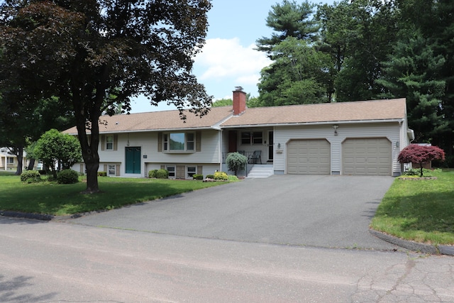 1 Sunrise Cir, Enfield, CT 06082 - split foyer home with an attached garage, asphalt driveway, a front yard, and a chimney