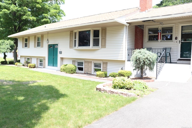1 Sunrise Cir, Enfield, CT 06082 - split foyer home with a front yard, a chimney, roof with shingles, and covered porch