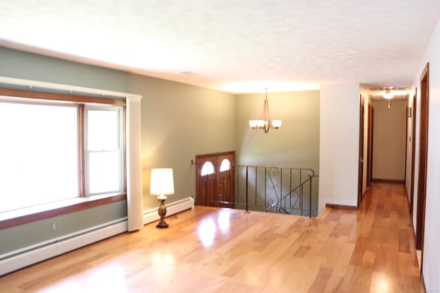 1 Sunrise Cir, Enfield, CT 06082 - foyer featuring a baseboard heating unit, wood finished floors, and a chandelier