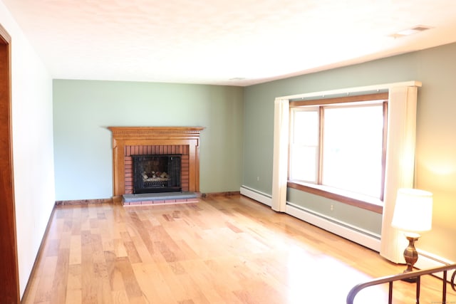 1 Sunrise Cir, Enfield, CT 06082 - unfurnished living room with wood finished floors, baseboard heating, and a fireplace
