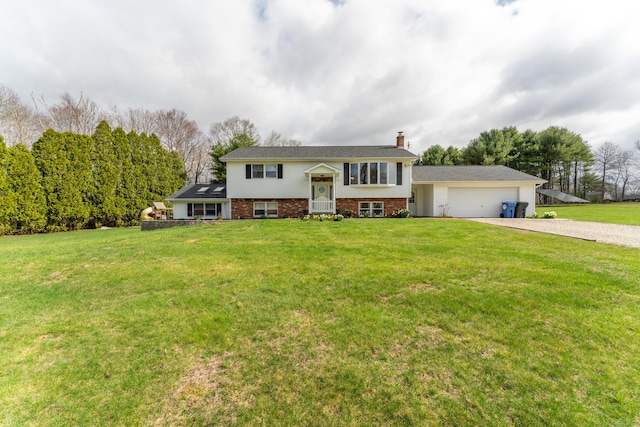 17 Old Hampton Rd, Canterbury, CT 06331 - split foyer home featuring driveway, a chimney, brick siding, a front yard, and an attached garage