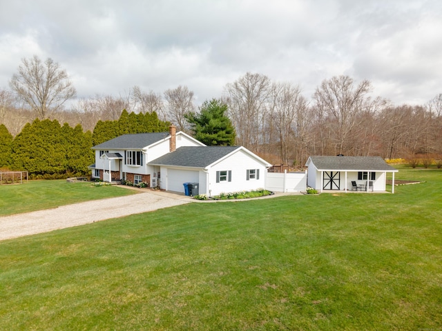 17 Old Hampton Rd, Canterbury, CT 06331 - rear view of house featuring dirt driveway, an attached garage, a chimney, and view of scattered trees