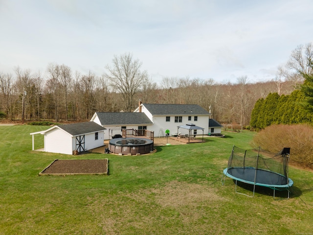 17 Old Hampton Rd, Canterbury, CT 06331 - back of property featuring a trampoline, a gazebo, a lawn, and an outbuilding