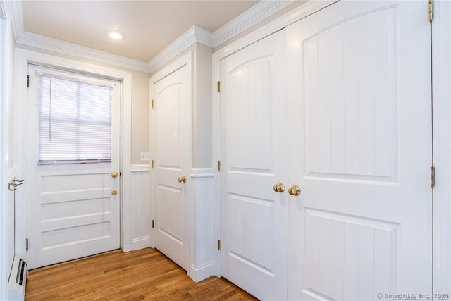 26 Columbia St, Ansonia, CT 06401 - doorway to outside with light wood-style floors, baseboard heating, and crown molding