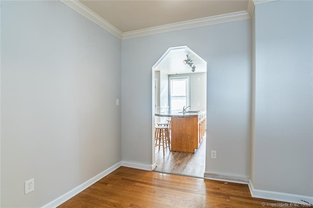 26 Columbia St, Ansonia, CT 06401 - interior space with baseboards, arched walkways, a sink, ornamental molding, and wood finished floors