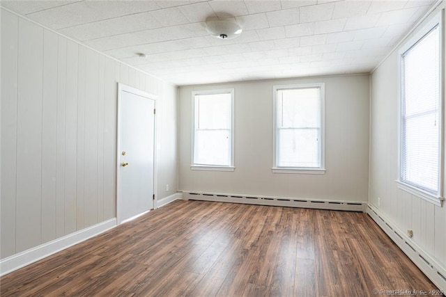 26 Columbia St, Ansonia, CT 06401 - unfurnished room featuring a baseboard radiator, wood finished floors, and plenty of natural light