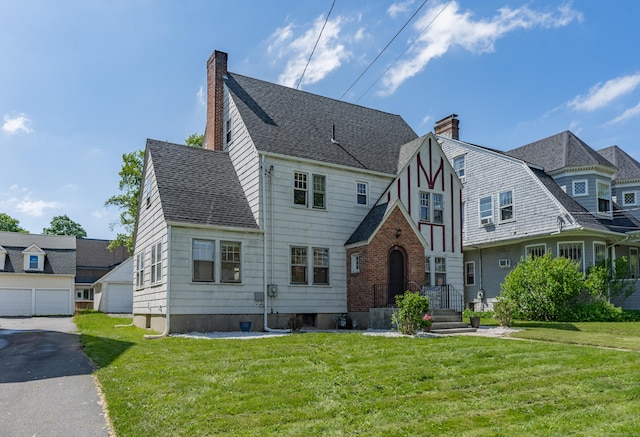 25 S Highland St, West Hartford, CT 06119 - view of front of property with a chimney, a front lawn, and a shingled roof