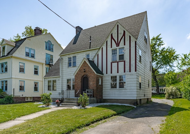 25 S Highland St, West Hartford, CT 06119 - view of front of property featuring a front lawn, a shingled roof, and a chimney