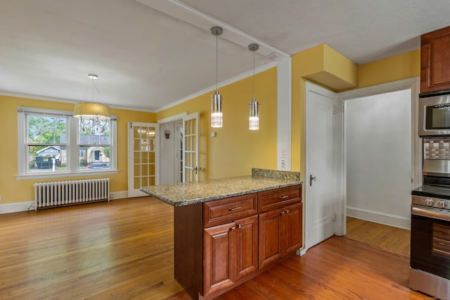 25 S Highland St, West Hartford, CT 06119 - kitchen featuring radiator, stainless steel appliances, light wood-type flooring, baseboards, and ornamental molding