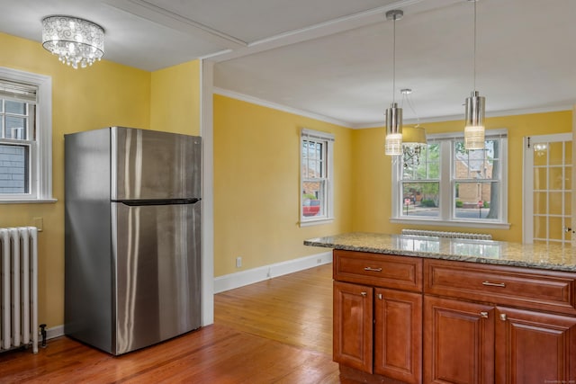 25 S Highland St, West Hartford, CT 06119 - kitchen with freestanding refrigerator, radiator heating unit, light wood-type flooring, baseboards, and light stone countertops