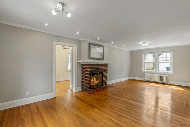 25 S Highland St, West Hartford, CT 06119 - unfurnished living room with radiator, crown molding, baseboards, light wood-style floors, and a fireplace