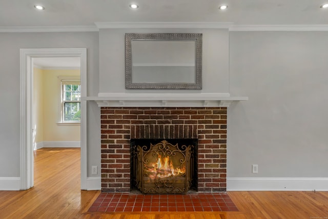 25 S Highland St, West Hartford, CT 06119 - detailed view of a fireplace, wood finished floors, baseboards, ornamental molding, and recessed lighting