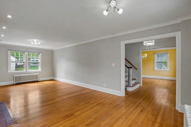 25 S Highland St, West Hartford, CT 06119 - empty room featuring radiator, a chandelier, crown molding, stairs, and light wood-style flooring