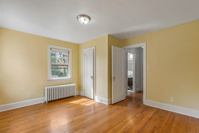 25 S Highland St, West Hartford, CT 06119 - unfurnished bedroom featuring radiator, baseboards, and light wood-style flooring