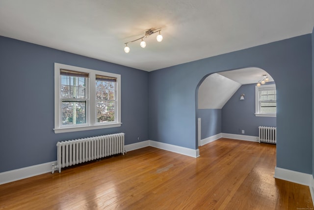 25 S Highland St, West Hartford, CT 06119 - bonus room with radiator heating unit, wood finished floors, arched walkways, and vaulted ceiling