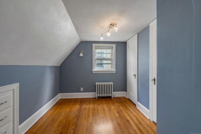 25 S Highland St, West Hartford, CT 06119 - additional living space with radiator, light wood-style flooring, baseboards, and lofted ceiling