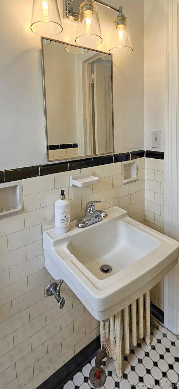 25 S Highland St, West Hartford, CT 06119 - bathroom featuring tile walls and wainscoting