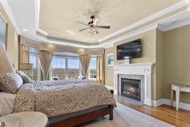 22 Nature Ln, Shelton, CT 06484 - bedroom with wood finished floors, a fireplace, a raised ceiling, crown molding, and baseboards