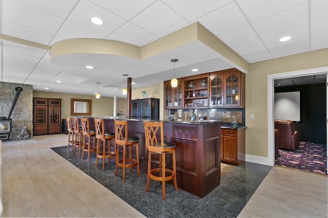 22 Nature Ln, Shelton, CT 06484 - indoor wet bar featuring a wood stove, recessed lighting, hanging light fixtures, wood finished floors, and backsplash