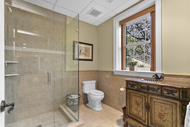 22 Nature Ln, Shelton, CT 06484 - full bathroom featuring a shower stall, tile patterned flooring, tile walls, toilet, and wainscoting