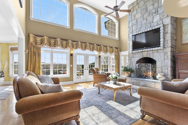 22 Nature Ln, Shelton, CT 06484 - living area with ornamental molding, a stone fireplace, baseboards, wood finished floors, and a high ceiling