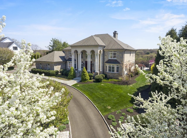 22 Nature Ln, Shelton, CT 06484 - view of front of house featuring stone siding, a chimney, and a front lawn
