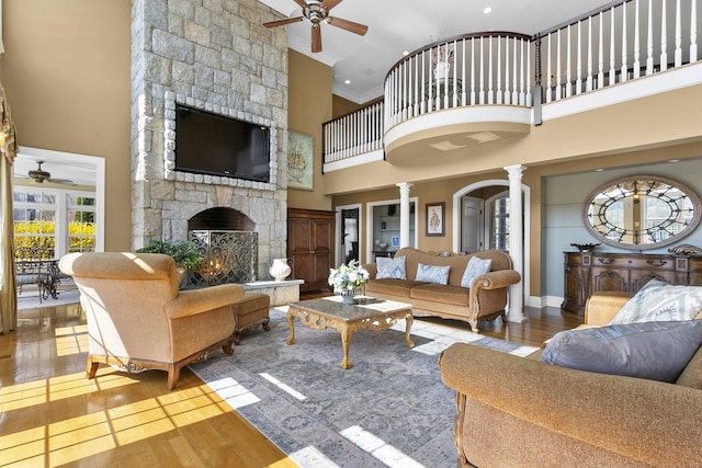 22 Nature Ln, Shelton, CT 06484 - living room with a ceiling fan, decorative columns, crown molding, a fireplace, and hardwood / wood-style floors