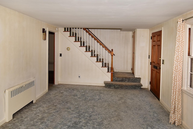 88 Milwood Rd, East Hartford, CT 06118 - below grade area featuring radiator heating unit, carpet floors, and stairway