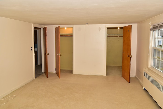 88 Milwood Rd, East Hartford, CT 06118 - unfurnished bedroom featuring radiator heating unit, multiple closets, baseboards, and light colored carpet