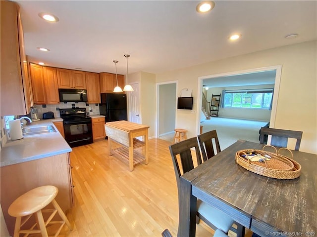 dining space with recessed lighting and light wood-type flooring
