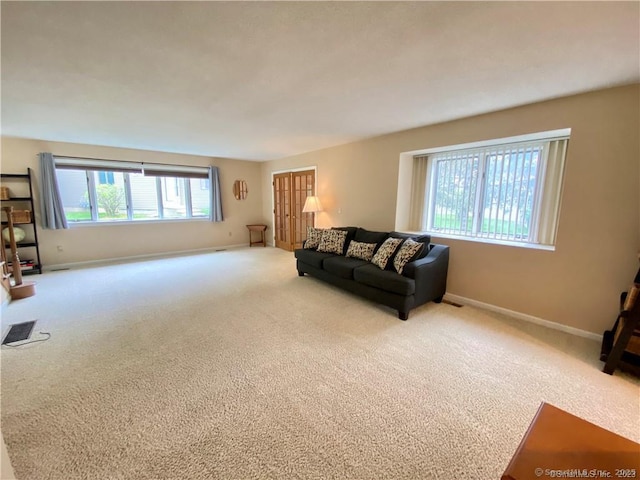 living area with a wealth of natural light and carpet flooring
