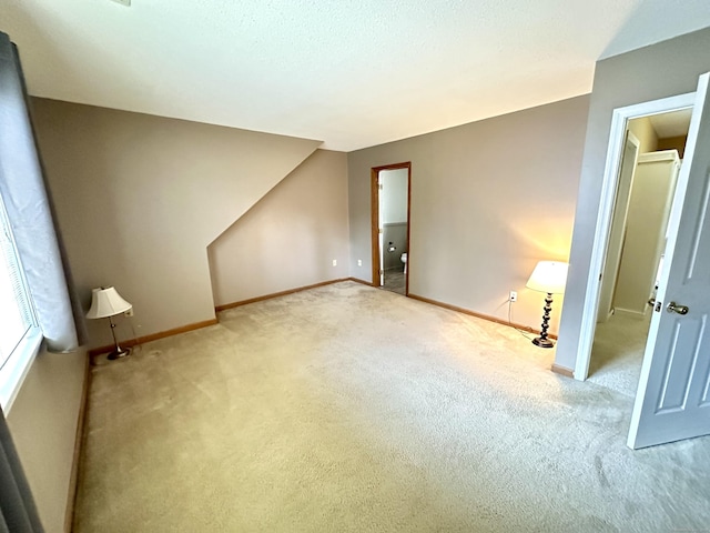 unfurnished bedroom with carpet floors and baseboards