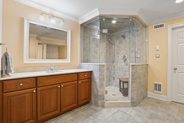 bathroom with a shower stall, crown molding, vanity, and visible vents