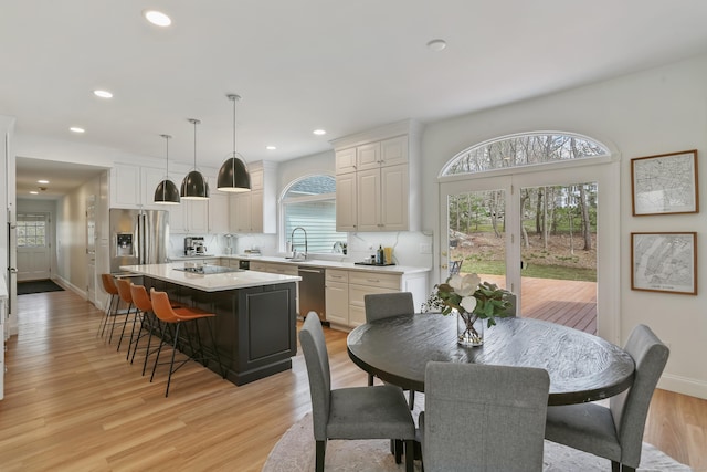 dining area featuring baseboards, recessed lighting, and light wood-style floors