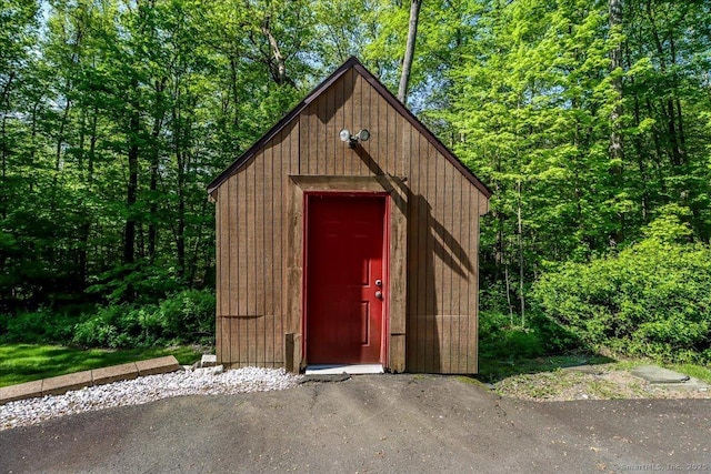 view of shed featuring a wooded view