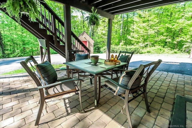 view of patio with stairway and outdoor dining area