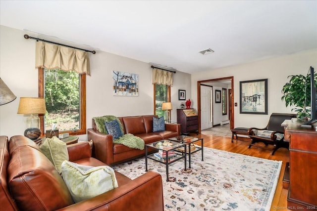 living room featuring wood finished floors and baseboard heating