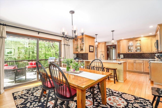 dining room with a chandelier, light wood-style flooring, and recessed lighting