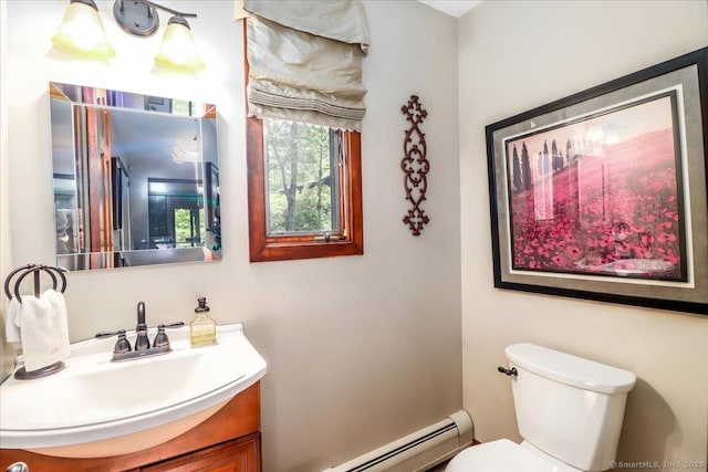 half bathroom featuring toilet, vanity, and a baseboard heating unit