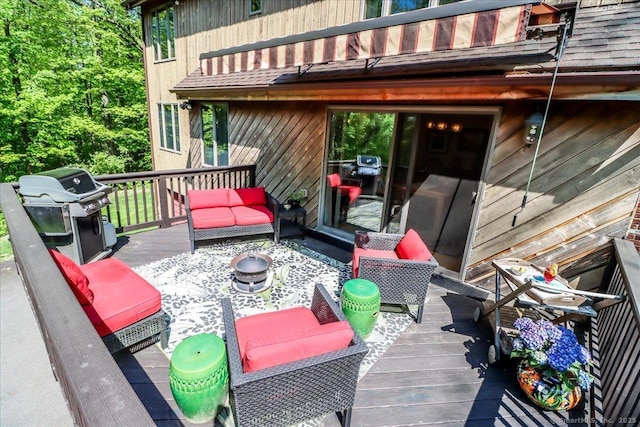 wooden deck with a grill and an outdoor hangout area