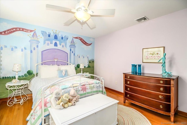 bedroom featuring wood finished floors, ceiling fan, and baseboards