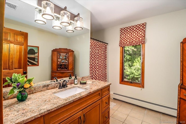 bathroom with baseboard heating, tile patterned flooring, vanity, and a chandelier