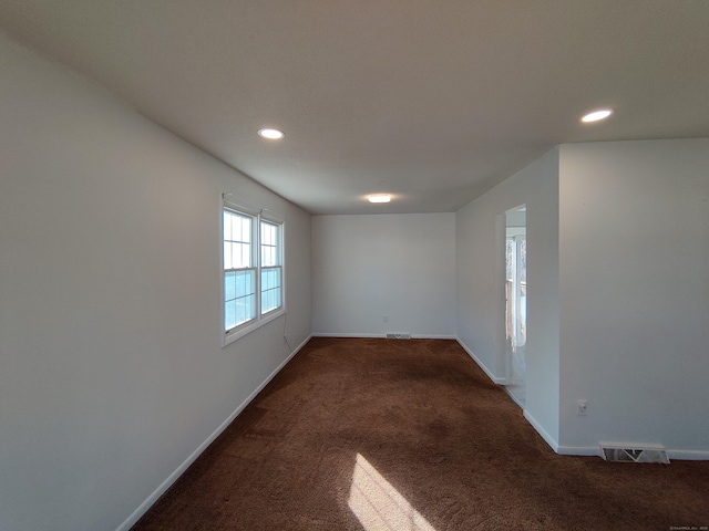 carpeted spare room with recessed lighting, visible vents, and baseboards