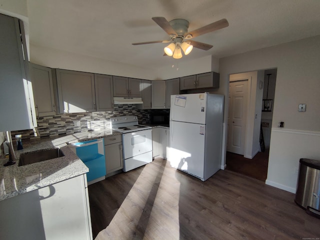 kitchen with under cabinet range hood, a ceiling fan, white appliances, gray cabinetry, and tasteful backsplash