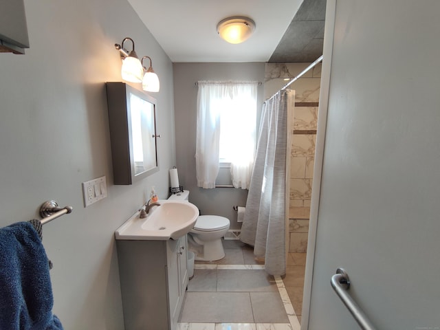 full bathroom featuring toilet, vanity, tile patterned floors, and tiled shower